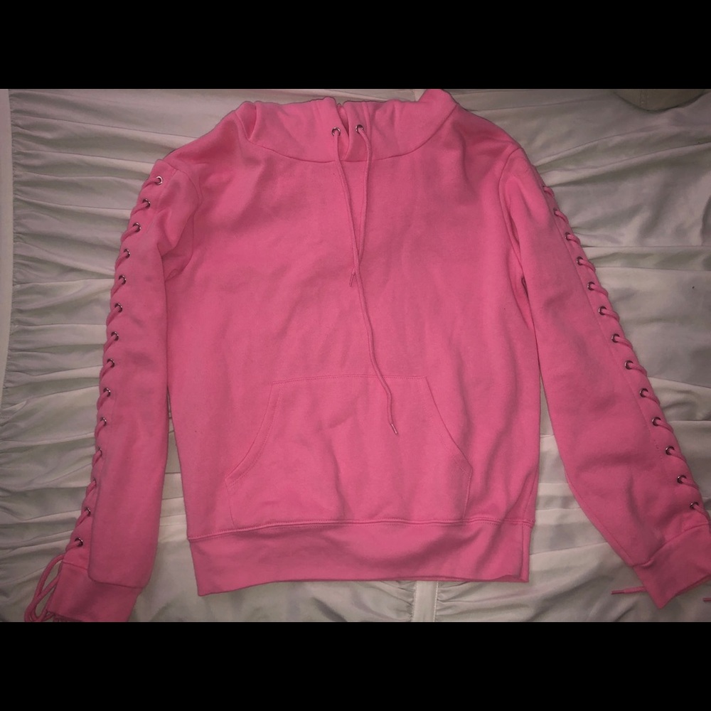 pink sweatshirt with ties up the arms